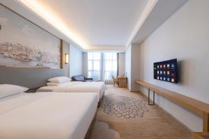 Voodi või voodid majutusasutuse Vienna Hotel toas