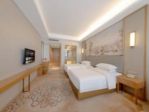 Voodi või voodid majutusasutuse Vienna Hotel toas