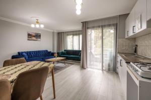 a kitchen and living room with a couch and a table at LOYA HOME CiTY CENTeR in Trabzon +15 photos