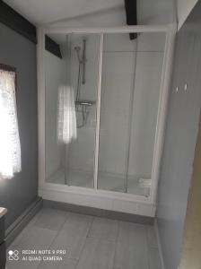 a shower stall with glass doors in a bathroom at Belle maison provençale in Castellane