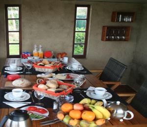 a table with fruits and vegetables on top of it at Quinta das Amendoeiras B&B in Nora