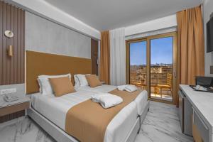 a hotel room with a large bed and a window at Rhodos Horizon Boutique-Adults only in Rhodes Town +27 photos