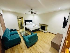 a bedroom with a bed and a couch and chairs at Joy House in Cape Town