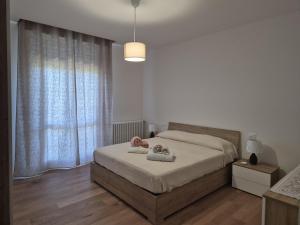 a bedroom with a bed with two teddy bears on it at allende100 in Cattolica