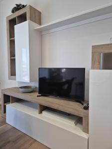 a living room with a television on a table at allende100 in Cattolica