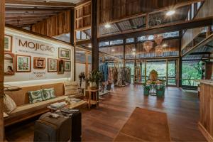 a large room with a couch and a table at Mojigao - Eco Resort in Assagao
