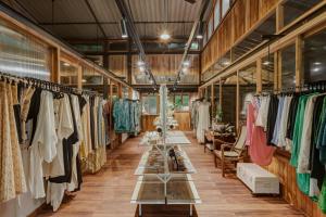 a clothing store with racks of clothes on display at Mojigao - Eco Resort in Assagao