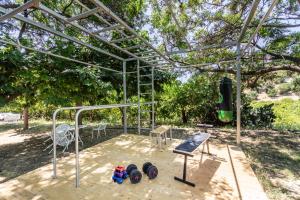 a batting cage with some equipment in a park at Agriturismo Val Di Noto in Noto +228 photos