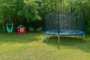 a playground with a trampoline and a swing at Driftwood Dreams in Cetinje