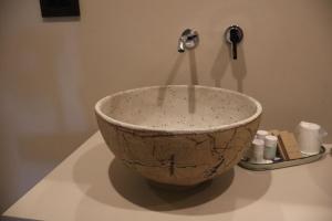 a bowl sitting on top of a counter with a faucet at Locanda A Cà Du Gigante in Monterosso al Mare
