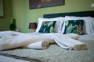 a bedroom with a bed with towels on it at vagia's studio in Alexandroupoli