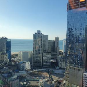 釜山にある해운대엘본더스테이の建物と海を望む市街の景色 +4枚の写真