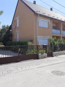 a fence in front of a house at Ibolya in Balatonfüred