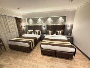 A bed or beds in a room at Blue Istanbul Hotel Taksim