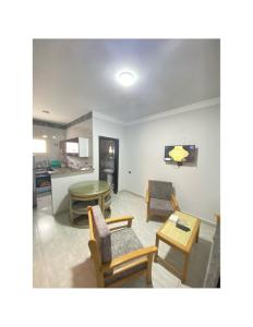 a living room with chairs and a table at Jewel Inn Matrouh in Marsa Matruh