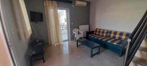 a living room with a couch and a window at Leonidas Apartments in Preveza
