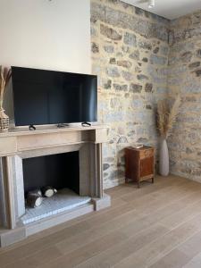 a living room with a fireplace with a flat screen tv at Le Boulevard Suites & Apartments in Olbia