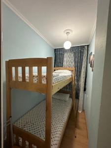 a small room with two bunk beds in it at Krena Apartament in Durrës