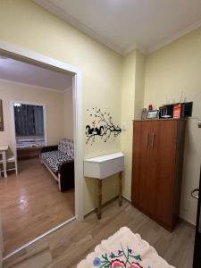 a living room with a sink and a bedroom at Krena Apartament in Durrës