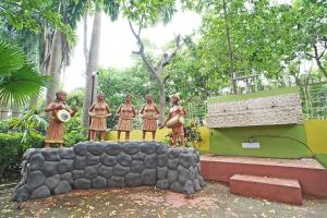 a group of men standing on a rock wall at Whispering Woods Inn - Stay & Enjoy in Nature ! in Bolpur