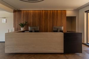 an office lobby with a wooden wall at Eleonas Boutique Hotel & Spa - Adults Only in Ialysos +44 photos