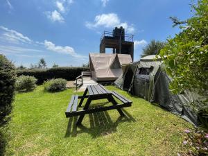a picnic table and a tent in the grass at Camping Near Mt Longonot, Elwai Camping Centre in Heni Village