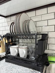 un estante con platos y tazas de café. en Brand new - Stylish Studio Near to Yas & Airport, en Abu Dabi 15 fotos más