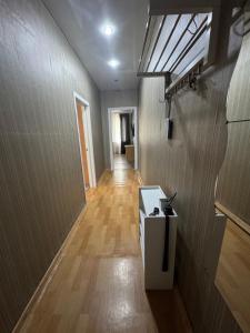 a room with a hallway with wood floors and a ceiling at 2-х комнатная квартира in Balqash