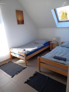 Postel nebo postele na pokoji v ubytování Relax Porta Vendégház Orfű