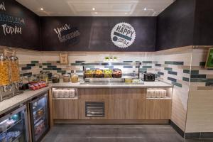 a fast food restaurant with a counter with food at Hampton by Hilton Bournemouth in Bournemouth