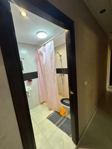 a bathroom with a shower and a toilet in a room at Dar AMIRA in Ben Yakhlef