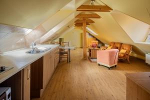 a kitchen with a sink and a dining room at Down Town Apartment with Garden in Piešťany