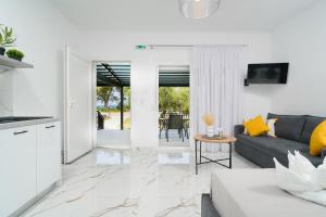 a living room with a couch and a table at Sunelia Thassos in Skala Kallirachis
