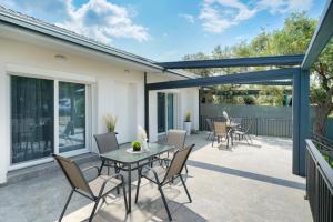 a patio with a table and chairs at Sunelia Thassos in Skala Kallirachis