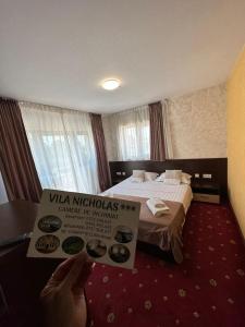 Postel nebo postele na pokoji v ubytování Vila NICHOLAS