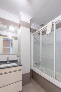 a bathroom with a glass shower and a sink at San Anton, Ventana al mar in Llanes +10 photos