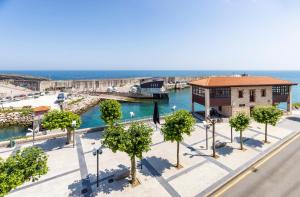 an aerial view of a marina with trees and a building at San Anton, Ventana al mar in Llanes