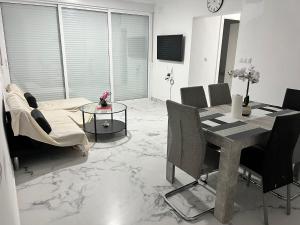 a living room with a dining room table and chairs at Luxury flat Mar de Cristal in Mar de Cristal