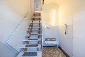 a staircase in a room with a bench and a chair at Ferienwohnung Alte Meierei in Gelting +14 photos