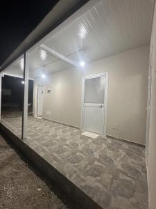an empty room with a door and a stone floor at Apartment Himare Livadhe in Himare