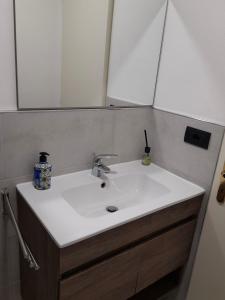 a bathroom with a white sink and a mirror at Le 3 Finestre in Peccioli