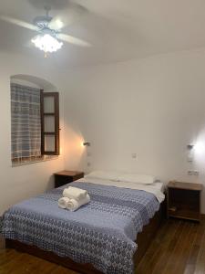 a bedroom with a bed with two towels on it at Old Town Traditional House in Kos Town