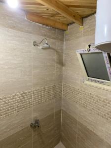 a bathroom with a shower with a television in it at Rayan stay in Dahab