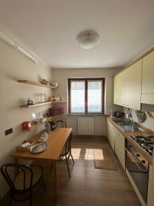 a kitchen with a wooden table and a wooden floor at Civico60 in Solbiate Arno