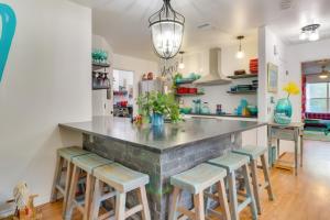 a kitchen with a large counter with stools at Bright Georgetown Gem N Blue Hole Park w Swings in Georgetown