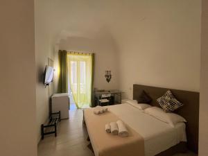 a bedroom with a bed with two towels on it at La Torre in Catania