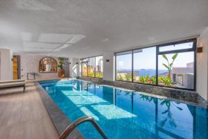 a swimming pool with a view of a building at Eco Villa Supernova in Kalkan