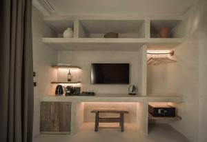 a living room with a table and a tv at Wakana Alaçatı in Alacati