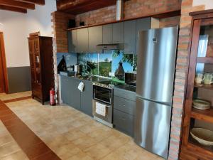 a kitchen with a stainless steel refrigerator at Nemeskerék Vendégház in Nemesnép +19 photos