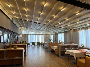 a restaurant with tables and chairs in a room at Hotel Bukhara in Bukhara